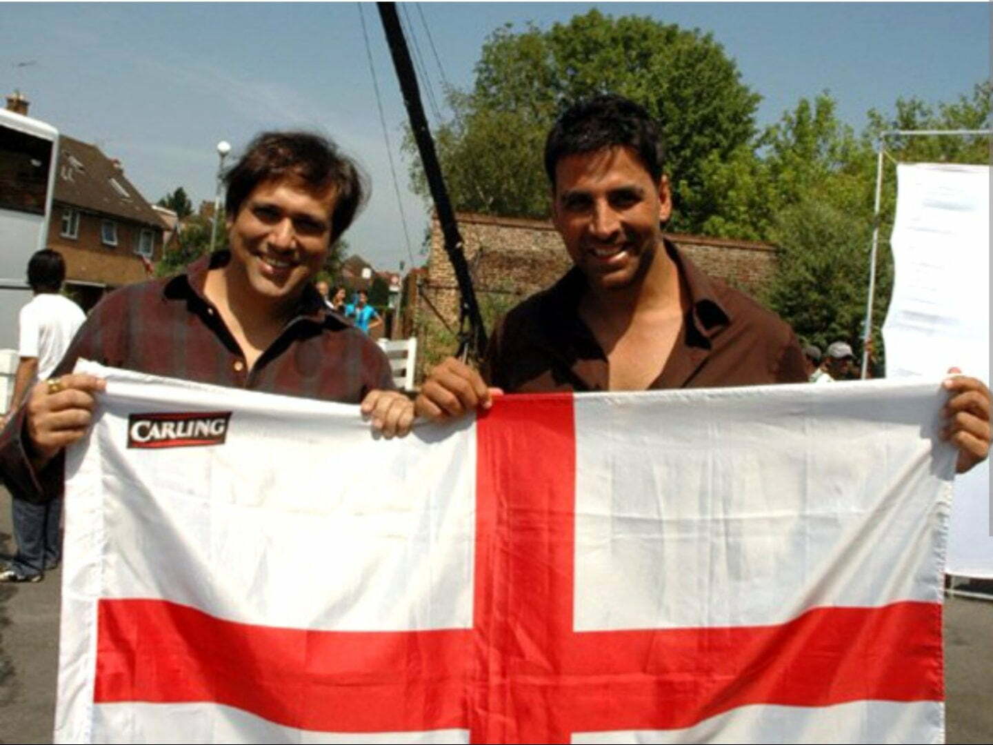 Govinda and Akshay Kumar holding an English flag Govinda (left) with Akshay Kumar on the set of Bhagam Bhag